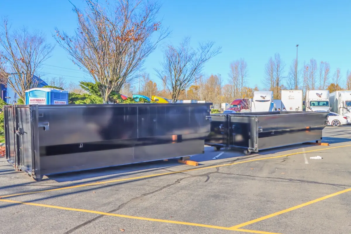 Professional dumpster rental service with roll-off container on residential driveway in Rockford